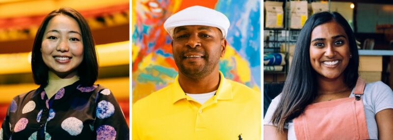 two young women smiling and one middle-aged man smiling