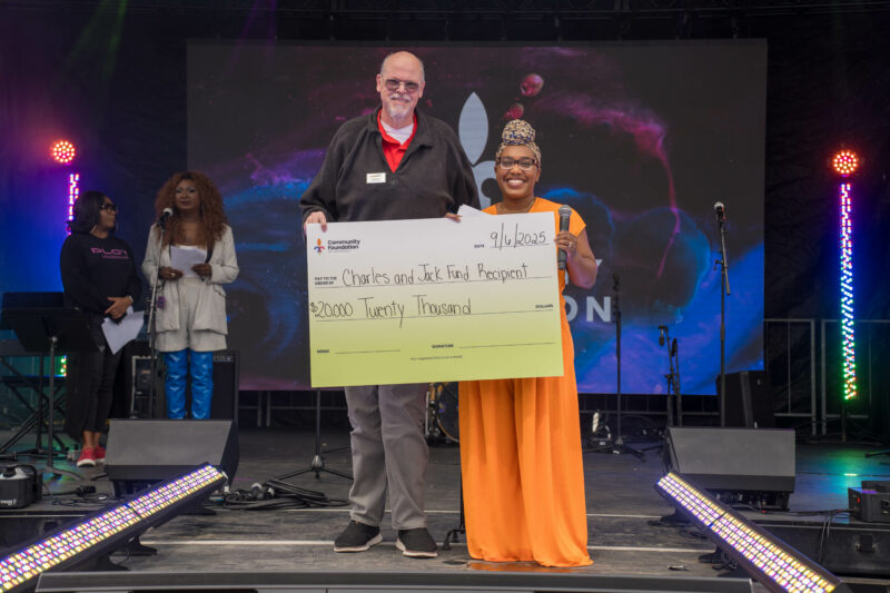 Community Foundation's Amber Burns-Jones presents a $20,000 check to Keith Elston of Kentucky Youth Law Project