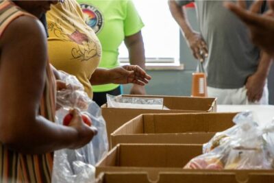 Volunteers from Change Today, Change Tomorrow organize and distribute fresh produce to local residents through their Feed the West programming during Give for Good Louisville.