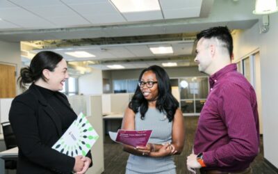 Diverse group of young, middle-aged people talking annd smiling.