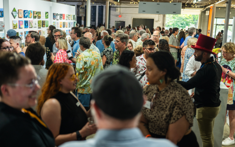 Pictured: a crowd talking to each other and viewing art at Louisville Visual Art's art[squared] reception.